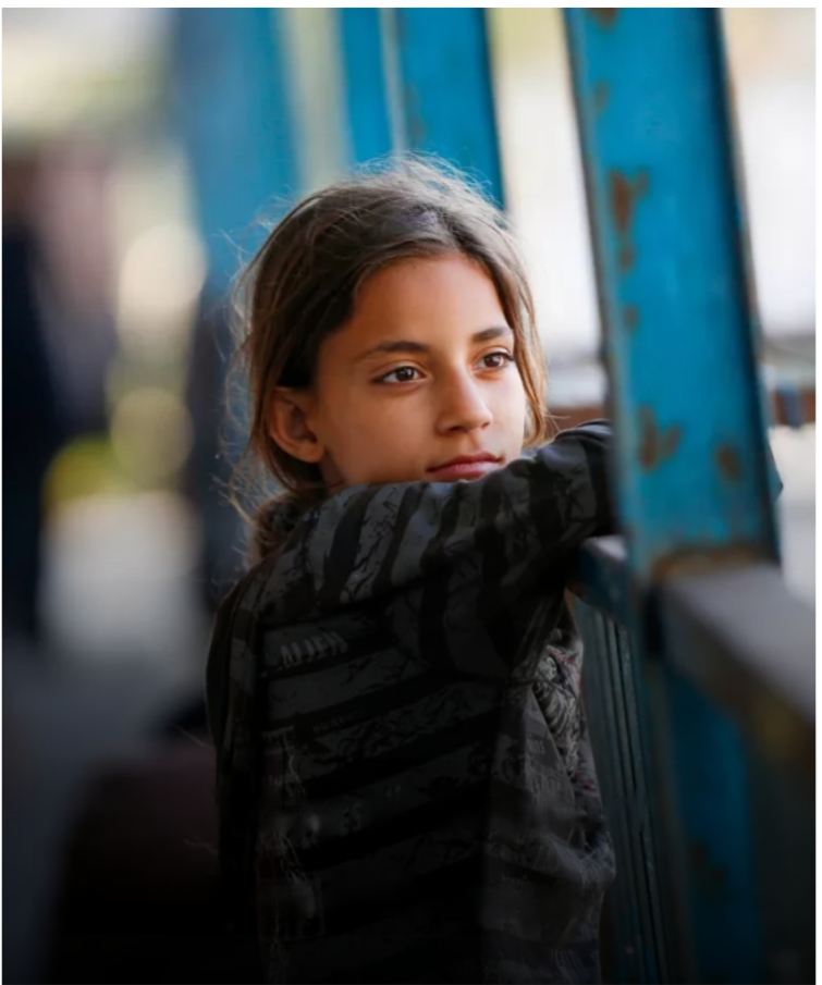 A young girl looking through UNRWA shelter